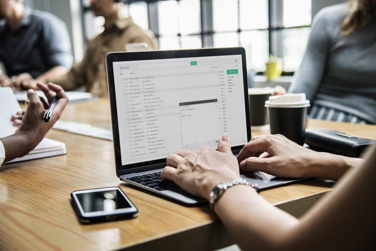 Woman checking her email in a meeting